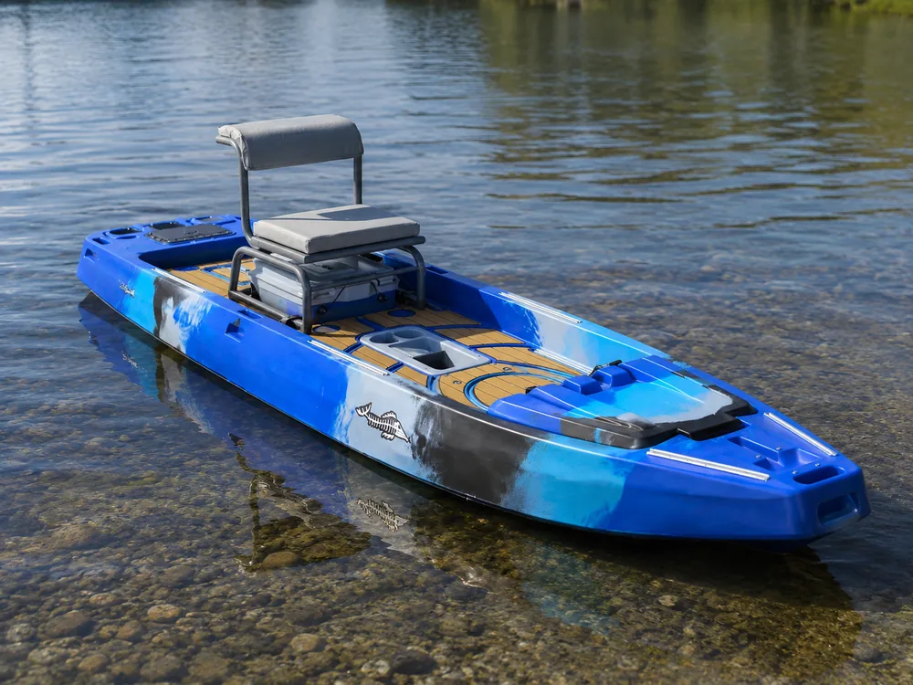 A blue fishing kayak in shallow clear water fitted with a raised pedestal seat and a teak-look deck