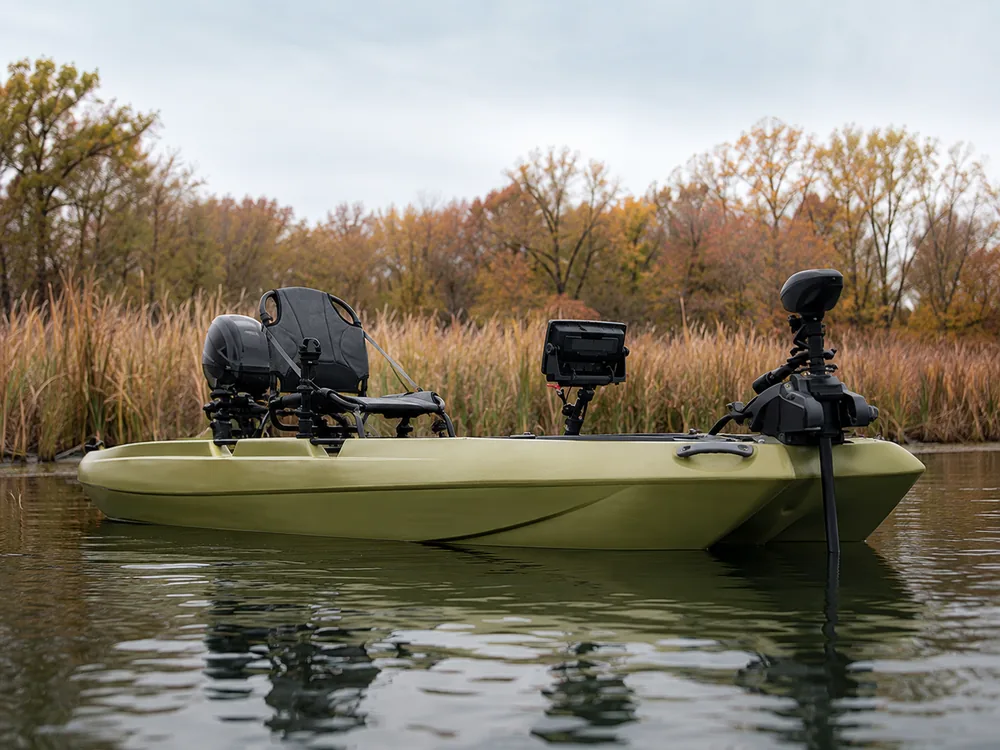 Side view of an olive fishing kayak on the water with a bow-mounted trolling motor and a fish finder screen on a track mount